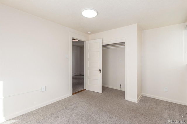 unfurnished bedroom featuring a closet and carpet