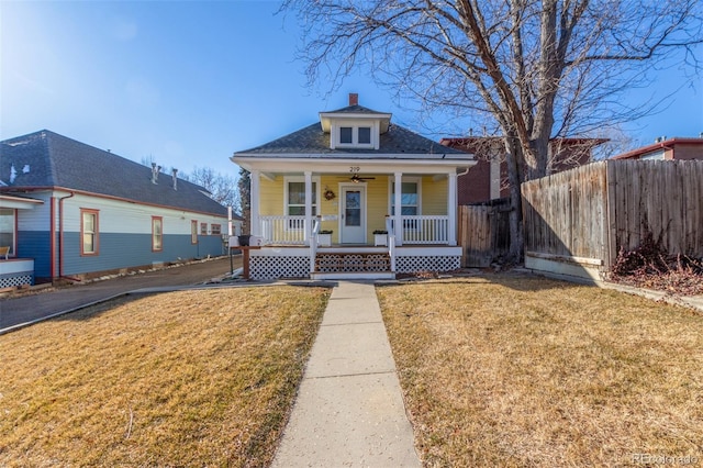 bungalow-style home with a front yard and covered porch