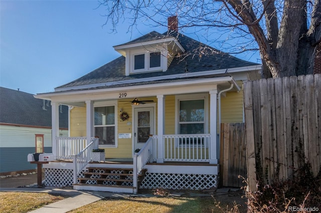 219 Terry St, Longmont, CO 80501 - view of front of house with a porch, a shingled roof, and a chimney