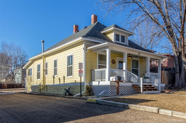 219 Terry St, Longmont, CO 80501 - view of front facade featuring covered porch, ceiling fan, and a chimney