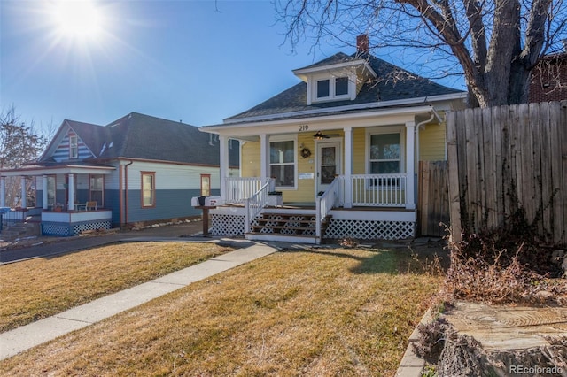 219 Terry St, Longmont, CO 80501 - view of front of property with a porch, a ceiling fan, a shingled roof, and a chimney