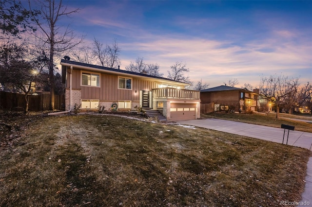 view of front of house with a lawn, a wooden deck, and a garage