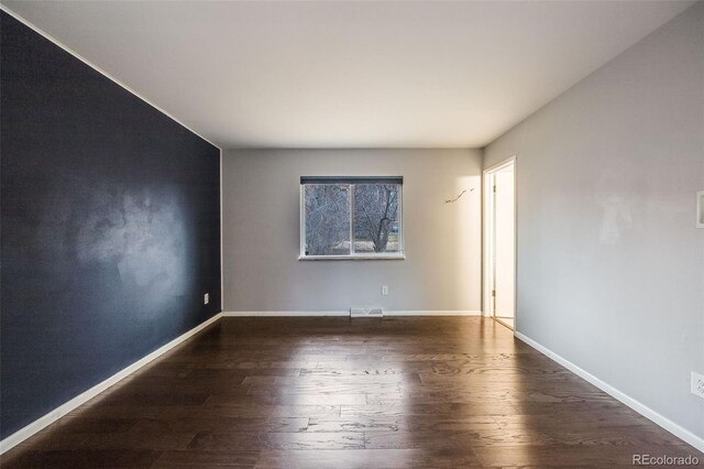 empty room featuring dark hardwood / wood-style floors