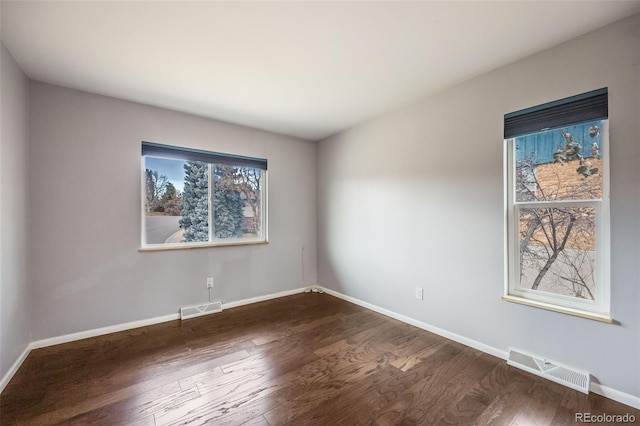 empty room featuring dark hardwood / wood-style flooring