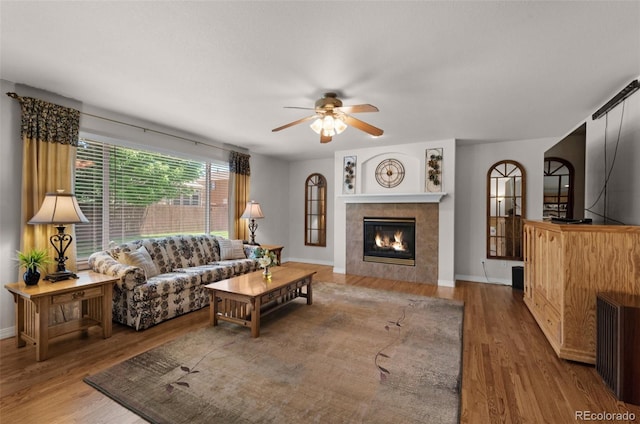 10643 Black Kettle Way, Colorado Springs, CO 80908 - living area featuring a ceiling fan, wood finished floors, and a fireplace