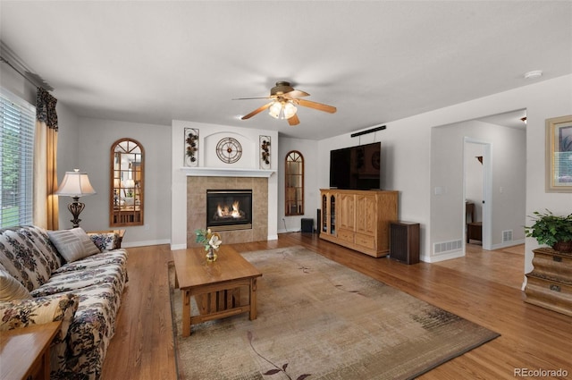 10643 Black Kettle Way, Colorado Springs, CO 80908 - living room with a ceiling fan, wood finished floors, and a tile fireplace