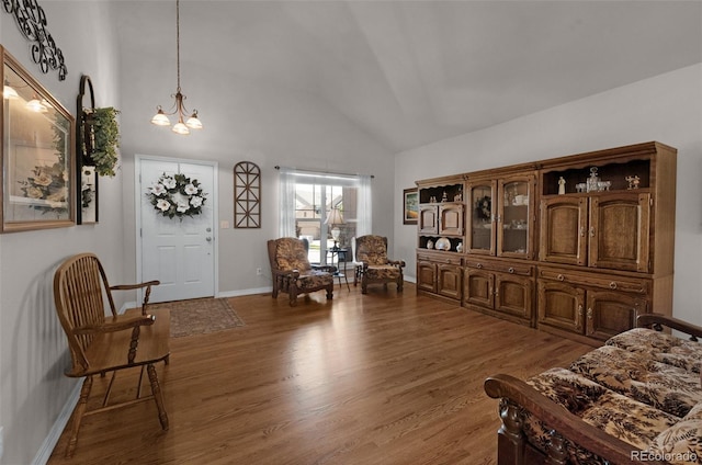10643 Black Kettle Way, Colorado Springs, CO 80908 - sitting room featuring wood finished floors, a chandelier, and high vaulted ceiling