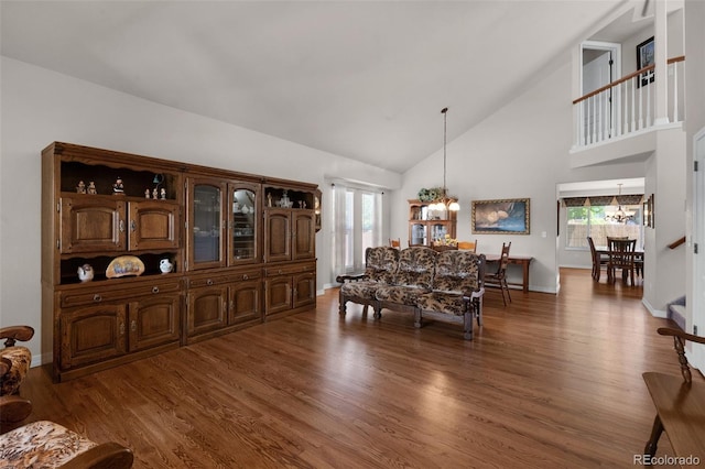 10643 Black Kettle Way, Colorado Springs, CO 80908 - dining area with a chandelier, high vaulted ceiling, plenty of natural light, and wood finished floors