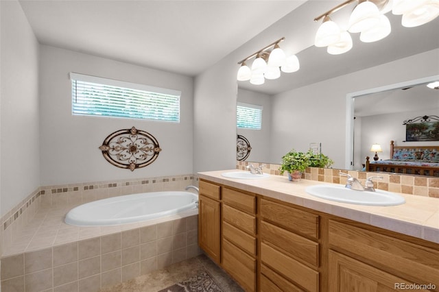 10643 Black Kettle Way, Colorado Springs, CO 80908 - ensuite bathroom featuring healthy amount of natural light, double vanity, a garden tub, and tile patterned floors