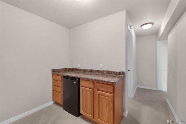 10643 Black Kettle Way, Colorado Springs, CO 80908 - indoor dry bar featuring refrigerator and light colored carpet