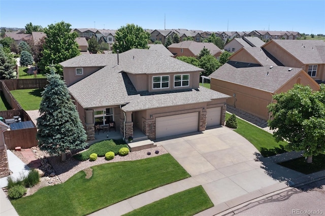 10643 Black Kettle Way, Colorado Springs, CO 80908 - view of front of home featuring stone siding, roof with shingles, a residential view, and concrete driveway
