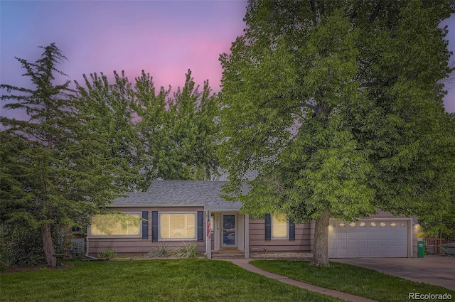 1697 W Powers Ave, Littleton, CO 80120 - view of front of home with concrete driveway, a front lawn, a garage, and a shingled roof