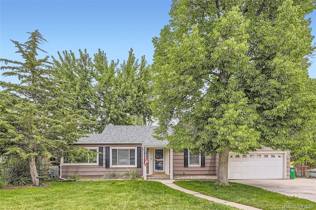 1697 W Powers Ave, Littleton, CO 80120 - view of front of home with concrete driveway, a front yard, a garage, and a shingled roof