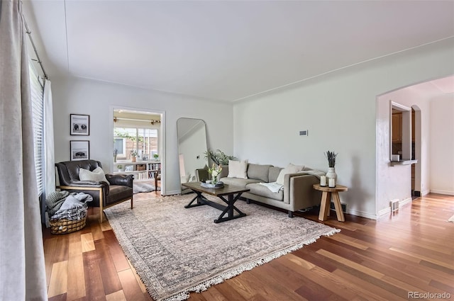 1697 W Powers Ave, Littleton, CO 80120 - living room with arched walkways, wood finished floors, and baseboards