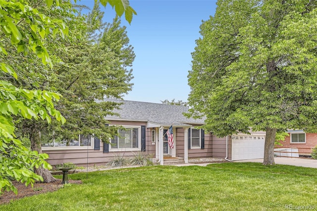 1697 W Powers Ave, Littleton, CO 80120 - view of front of home featuring a front lawn, concrete driveway, an attached garage, and a shingled roof