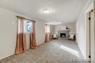 unfurnished living room featuring a textured ceiling and light carpet