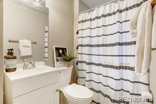 bathroom featuring vanity and toilet