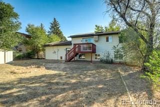 back of house featuring a wooden deck