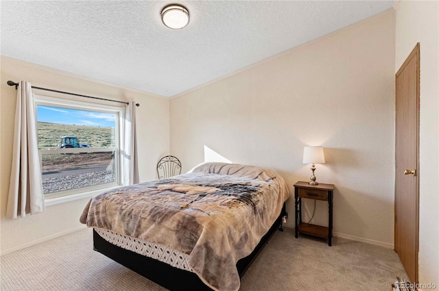 bedroom featuring light carpet and a textured ceiling