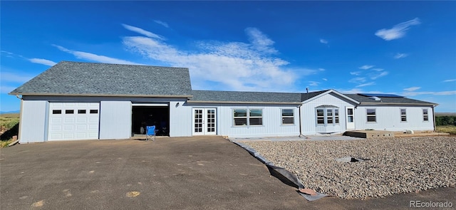 view of front of property featuring french doors and a garage