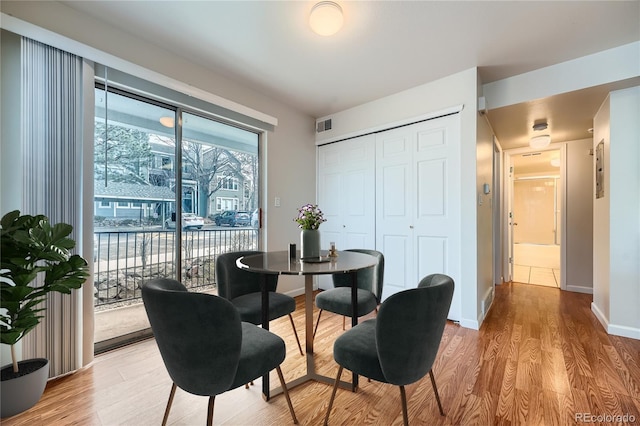 dining space with light hardwood / wood-style flooring