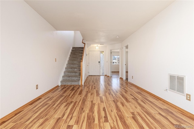 unfurnished living room featuring light wood-type flooring