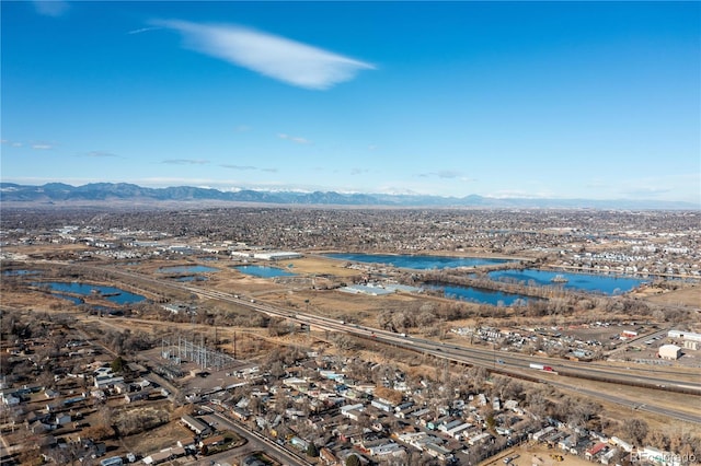 birds eye view of property with a water and mountain view