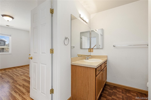 bathroom with vanity and hardwood / wood-style flooring