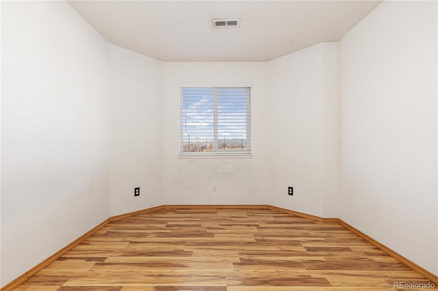 empty room with light hardwood / wood-style flooring