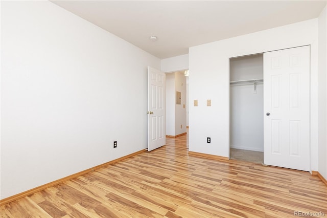 unfurnished bedroom featuring light hardwood / wood-style floors and a closet