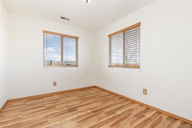 spare room featuring light hardwood / wood-style flooring