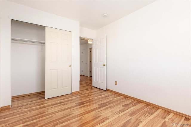 unfurnished bedroom featuring a closet and light hardwood / wood-style flooring