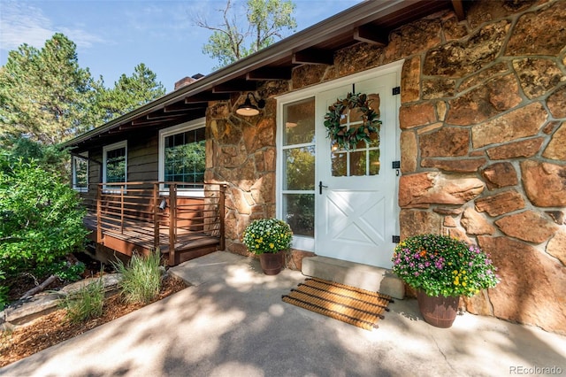 5465 W Ontario Ave, Littleton, CO 80128 - view of exterior entry with stone siding and a chimney