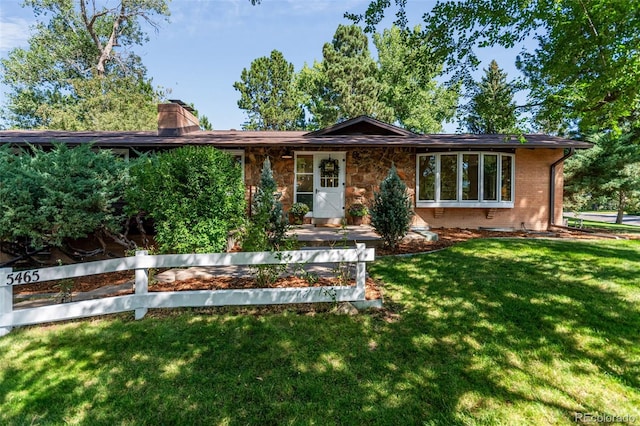 5465 W Ontario Ave, Littleton, CO 80128 - view of front of house featuring a front lawn, a chimney, and brick siding