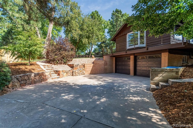5465 W Ontario Ave, Littleton, CO 80128 - view of home's exterior featuring an attached garage, concrete driveway, and brick siding