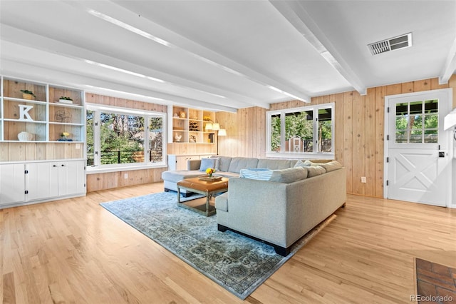 5465 W Ontario Ave, Littleton, CO 80128 - living area with wood finished floors, beam ceiling, and wood walls