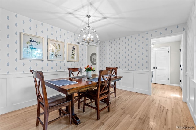 5465 W Ontario Ave, Littleton, CO 80128 - dining space with wallpapered walls, a wainscoted wall, light wood-type flooring, a chandelier, and a decorative wall