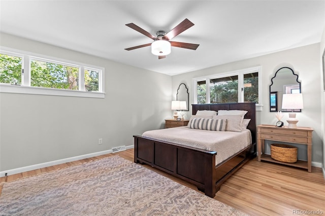 5465 W Ontario Ave, Littleton, CO 80128 - bedroom featuring multiple windows, light wood-type flooring, and a ceiling fan