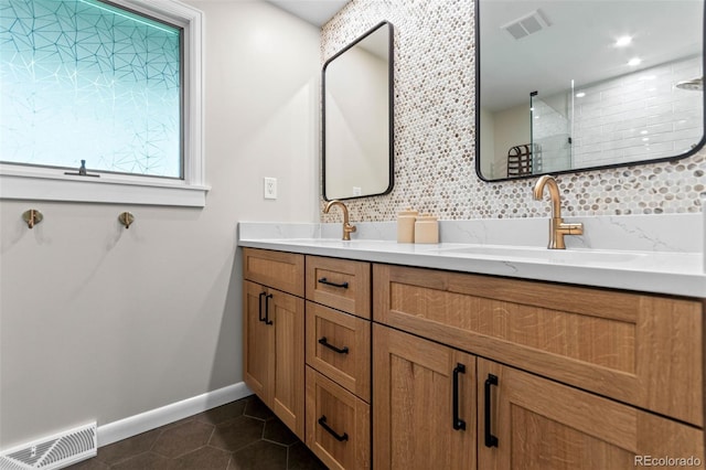 5465 W Ontario Ave, Littleton, CO 80128 - full bathroom featuring double vanity, tile patterned flooring, decorative backsplash, and a tile shower