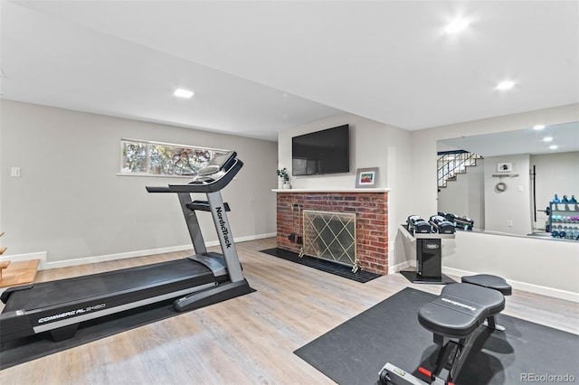 5465 W Ontario Ave, Littleton, CO 80128 - workout area with wood finished floors, a brick fireplace, and recessed lighting