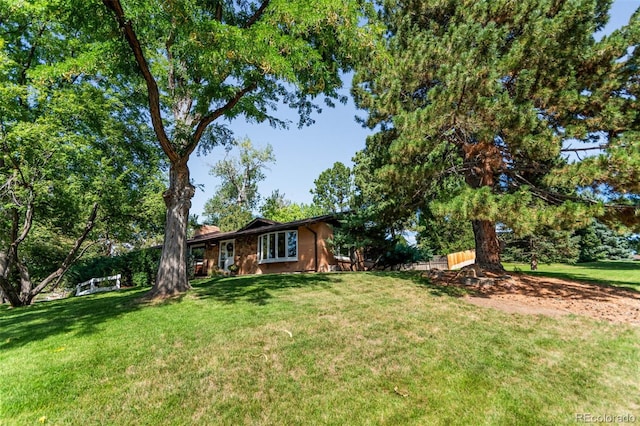5465 W Ontario Ave, Littleton, CO 80128 - view of front of home with a front lawn