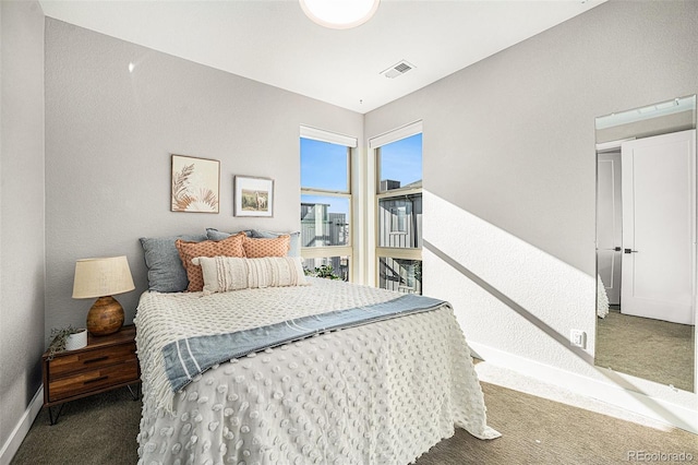 bedroom with dark carpet