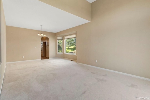 6449 S Jamaica Cir, Englewood, CO 80111 - empty room with carpet flooring, arched walkways, and a chandelier