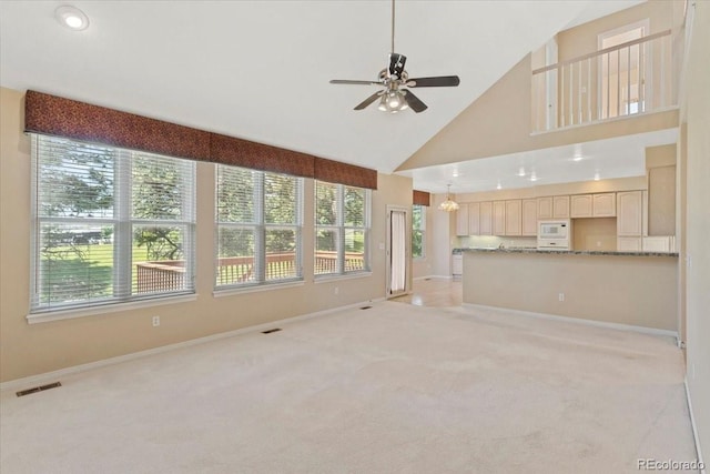 6449 S Jamaica Cir, Englewood, CO 80111 - unfurnished living room featuring high vaulted ceiling, light carpet, plenty of natural light, a ceiling fan, and recessed lighting