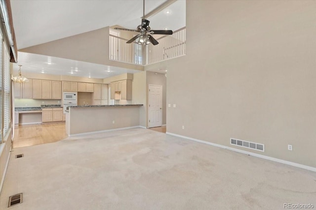 6449 S Jamaica Cir, Englewood, CO 80111 - unfurnished living room featuring light carpet, ceiling fan, and high vaulted ceiling