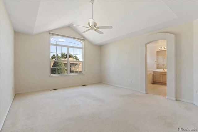 6449 S Jamaica Cir, Englewood, CO 80111 - unfurnished bedroom with arched walkways, light carpet, vaulted ceiling, ensuite bathroom, and a ceiling fan
