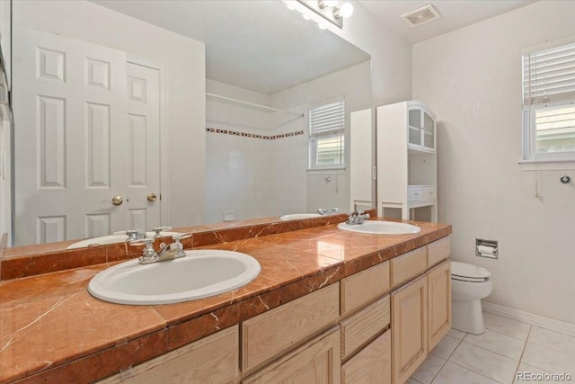 6449 S Jamaica Cir, Englewood, CO 80111 - full bath featuring double vanity, a tile shower, healthy amount of natural light, and tile patterned floors