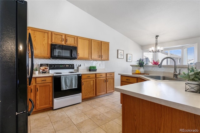 kitchen featuring lofted ceiling, a sink, light countertops, decorative backsplash, and black appliances