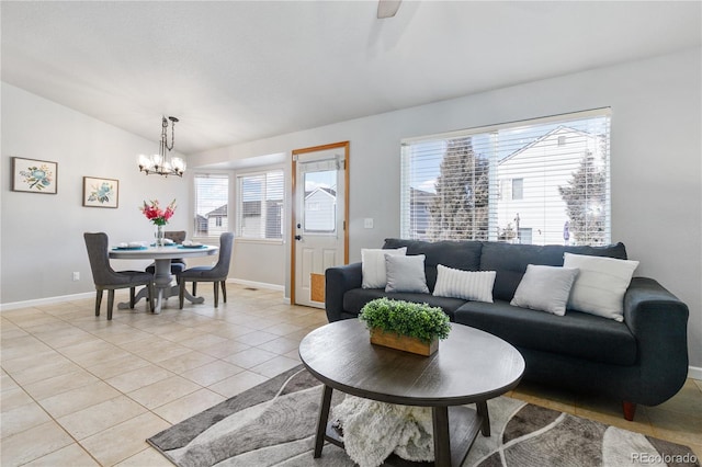 living room with vaulted ceiling, light tile patterned flooring, baseboards, and a notable chandelier