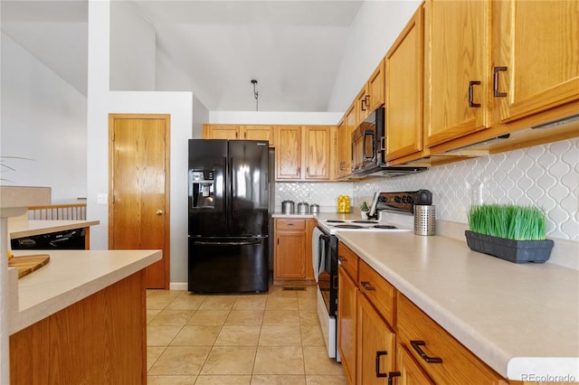 kitchen featuring light countertops, backsplash, black appliances, and light tile patterned floors